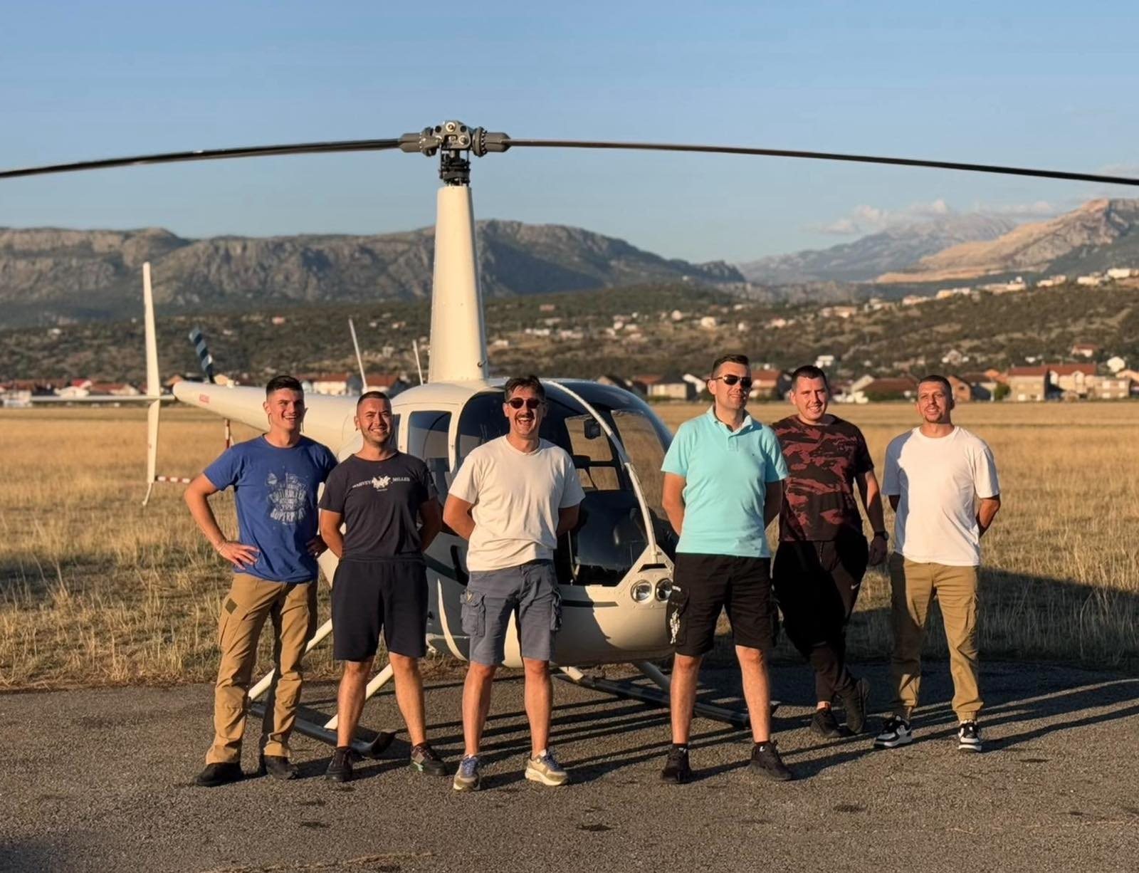 Former FAM students with helicopter